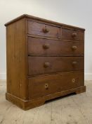 A Victorian pine chest fitted with two short and three long drawers raised on a plinth base.