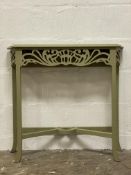 A green painted serpentine console table, the top with moulded edge above a floral fret carved