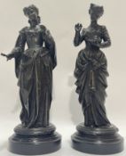 A large pair of spelter figures one of a lady with book in hand, the other with a mallet, mounted on