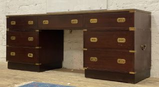 A Campaign style brass bound mahogany knee hole sideboard / desk, the leather inset top above one