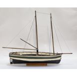 A model twin masted pond yacht on a wooden stand. L88cm.