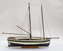 A model twin masted pond yacht on a wooden stand. L88cm.
