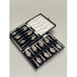 A set of six Sheffield silver boxed coffee spoons with fan shell terminals L 9.5cm Sheffiled 1938