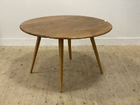Ercol, a vintage blonde elm and beech dining table, the circular top with two drop leaves raised