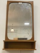 A mid century Danish wall hanging mirror with integrated open shelf, Danish control label verso.