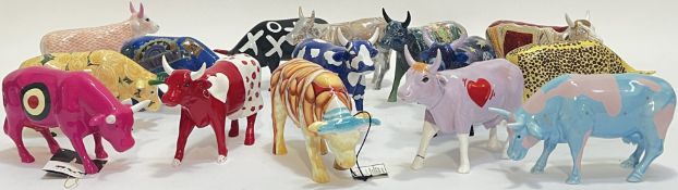 A group of fifteen Cow Parade ceramic cow figures, variously decorated including Broadway/Bullseye