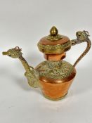 A late 19thc Persian brass-mounted copper rosewater ewer with domed cover with brass lotus bud and