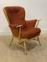 Ercol, a vintage blonde beech armchair, the hoop and spindle back enclosing squab cushions