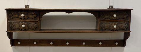 A late 19th/early 20th century oak hall rack, fitted with an open shelf and four acanthus carved
