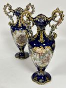 A pair of late 19thc continental earthenware two handled baluster vases with flared necks above a