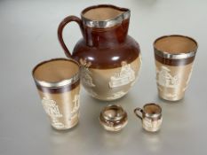 A group of silver-mounted Doulton Lambeth stoneware to include a cider jug and pair of matching