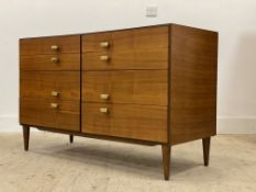 A mid century teak chest, fitted with eight drawers, raised on turned and tapered supports, possibly