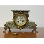 A late 19th century French green serpentine marble mantel clock, with white Ivorine dial, stepped