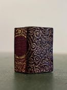 A gilt leather bound miniature Quran/Koran (h- 2.6cm, w- 1.9cm)