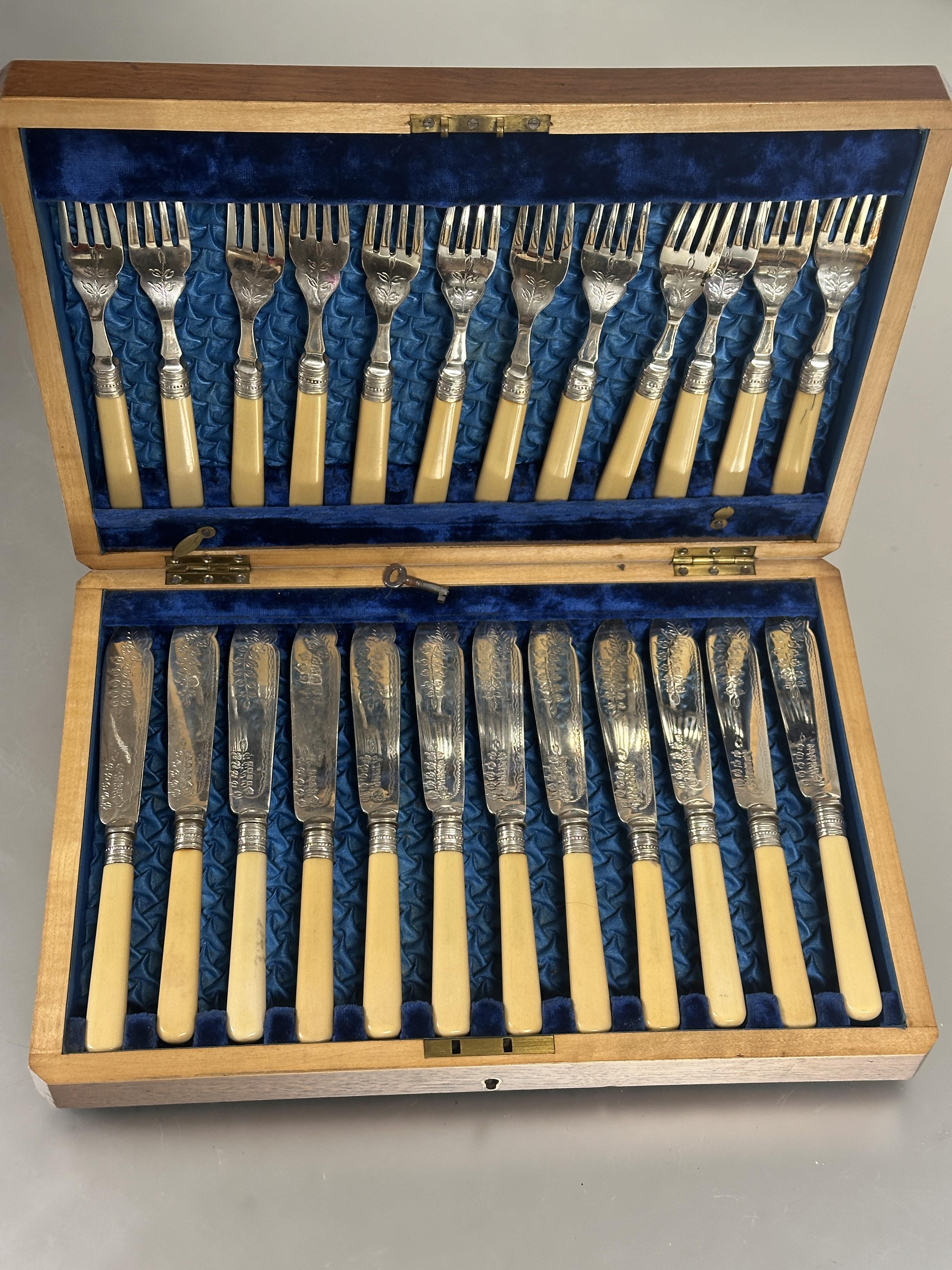 An Edwardian mahogany inlaid case containing a set of twelve pairs of Epns  plastic-handled fish