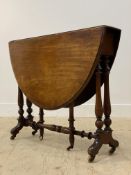 A Victorian mahogany stretcher table, the oval top with twin drop leaves and moulded edge raised