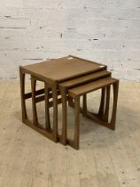 A mid century teak nest of three tables. H50cm, W54cm, D40cm.