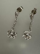 A pair of 18ct white gold Edwardian style diamond daisy flower head drop earrings with miligrain set