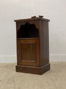 An early 20th century walnut bedside cabinet, with raised back over open shelf and panelled cupboard