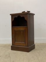 An early 20th century walnut bedside cabinet, with raised back over open shelf and panelled cupboard