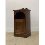 An early 20th century walnut bedside cabinet, with raised back over open shelf and panelled cupboard