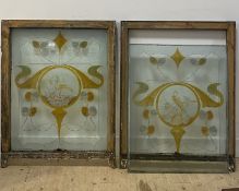 A pair of Art Nouveau hand painted glass and pine window panels, early 20th century, each