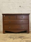 An early 20th century walnut chest fitted with two short and two long drawers, with bracket supports