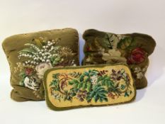 A 19thc style collection of three on green background hand-stitched decorative throw pillows, two
