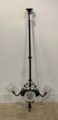 An early 20th century wrought iron electrolier ceiling light fitting, the column with pierced
