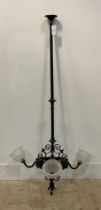 An early 20th century wrought iron electrolier ceiling light fitting, the column with pierced