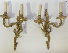 A pair of well cast gilt brass twin branch wall sconces, formed as scrolling acanthus leaves in