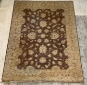A Ziegler carpet, the brown field with trailing lotus head design within an ivory border. 380cm x