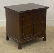 A Chinese style stained hardwood bedside cabinet, fitted with two panelled doors enclosing a