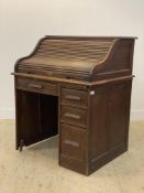 An Edwardian oak single pedestal roll top desk, the serpentine tambour top opening to a fitted