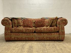 A Duresta two seat Chesterfield sofa, complete with squab and scatter cushions, raised on compressed