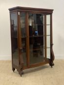 A Victorian mahogany bow front display cabinet, with a moulded frieze above glazed door and sides