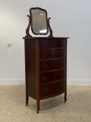 A mahogany and stained beech bow front chest, fitted with two short and four long drawers, raised on