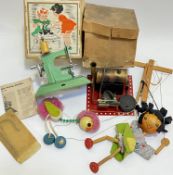 A group of vintage toys comprising two Pelham Puppets (ostrich and a child), a Mamod-type steam