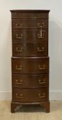 A Georgian style mahogany bow front chest on chest, fitted with six drawers, raised on bracket