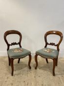 A pair of Victorian mahogany balloon back dining chairs with upolstered seat and cabriole front