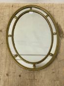 An Edwardian gold painted pine and composition oval wall hanging mirror 83cm x 62cm.