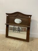 An early 20th century oak over mantel mirror, with oval plate above an open shelf and rectangular