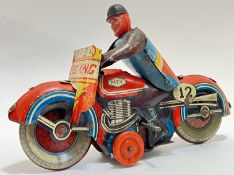 A vintage 'Speed King' tin plated mechanical motorcycle toy (marked 'MTY Made in GT Britain',