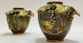 A pair of East Asian, probably Japanese, cast brass vases with textured surface and relief cast