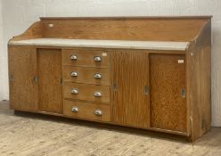 An early to mid 20th century douglas fir and plywood kitchen / bakery counter, the raised back