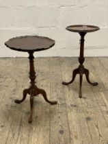 An Edwardian mahogany wine table, the circular dished top above a turned column and raised on triple