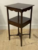 A Georgian mahogany two tier side table, fitted with a drawer and pot stand on the crossed stretcher