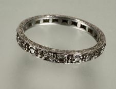 A Edwardian white metal diamond eternity ring set twenty miligrain set mixed cut stones with