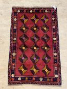 A hand knotted Baluchi rug of all over geometric design. 130cm x 83cm.