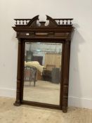 A large late Victorian oak framed wall hanging mirror, with arched and gallery pediment above a